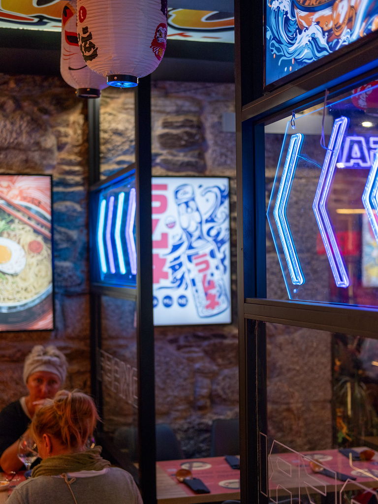 A corner of the dining room with lanterns, light boxes and stone walls